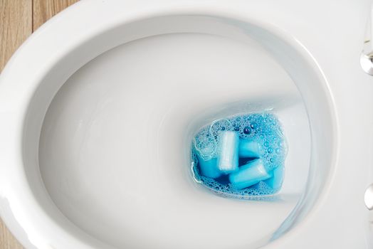 do not throw foreign objects, sanitary pads, tampons, paper, plastic into the toilet. Close-up of a toilet bowl clogged.