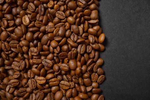Texture of coffee beans. Roasted coffee beans background. close up Coffee beans with copy space on Black background.