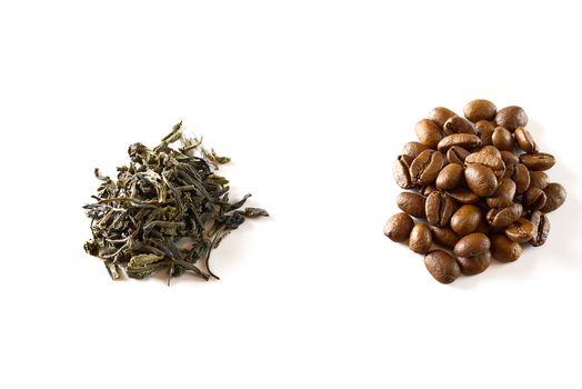 Pile of coffee beans and dry green tea leaves isolated on white background. closeup.