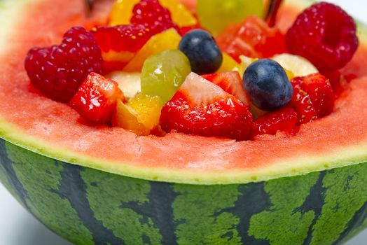 Watermelon filled with fresh fruit salad. summer fresh fruits salad close-up