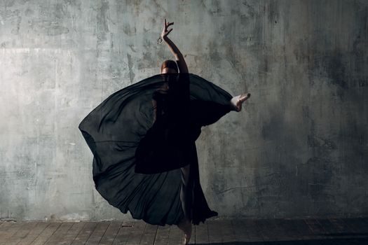 Ballerina female. Young beautiful woman ballet dancer, dressed in professional outfit, pointe shoes and black tutu.