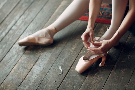 Ballerina female. Young beautiful woman ballet dancer, dressed in professional outfit, pointe shoes and black tutu.