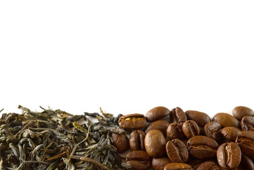 Pile of coffee beans and dry green tea leaves isolated on white background. closeup, copy space for your text.