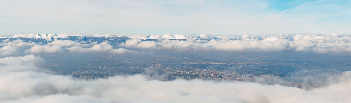 Wide angle aeria view of the canton of Geneva on a foggy winter day.