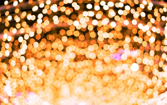 Orange beautiful blurred bokeh background. Glitter yellow light spots defocused. Suitable for copy space and background textures