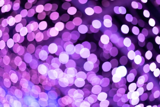 Purple beautiful blurred bokeh background. Glitter yellow light spots defocused. Suitable for copy space and background textures