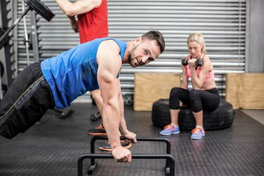 Fit people doing exercises at gym