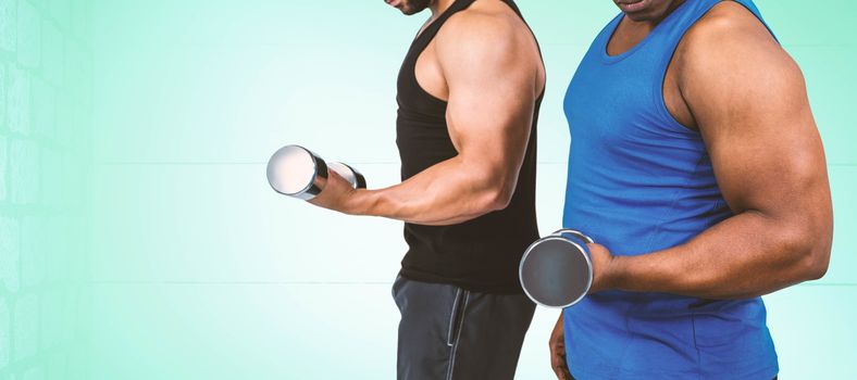 Strong friends posing with dumbbells against blue background