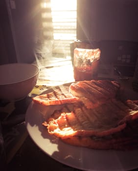 Freshly made breakfast, french croissant toasted in backlight