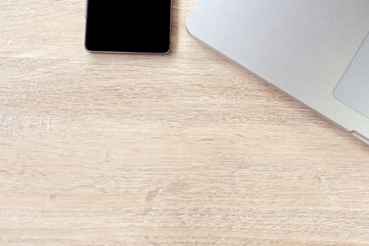 laptop and smartphone on the wood table