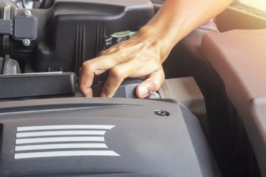 Hands of mechanic working in auto repair shop
Professional check oil filter and close oil filter cap