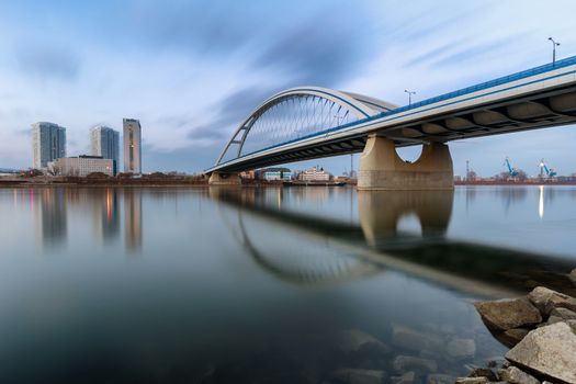 Apollo bridge in Bratislava, Slovakia with nice sunset and left part of river Danube with buildings