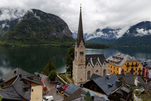 Views over roofs of the lake and Hallstatter and Hallstatt Lutheran Church. Location: resort village Hallstatt, Salzkammergut region, Austria, Alps. Europe.