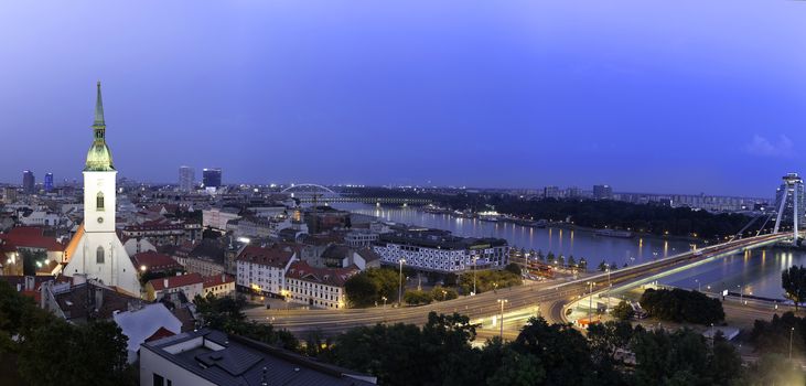 Panoramic view of Bratislava city with St. Martin's Cathedral and Danube river at night