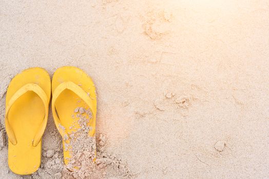 Summer holiday on the beach yellow sandals on the beach have sunset