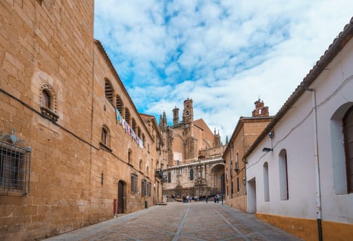 Street of old town of Plasencia with the New Cathedral of Plasencia or Catedral de Asuncion de Nuestra Senora on the background. It is a Roman Catholic cathedral located in the town of Plasencia, Region of Extremadura, Spain.