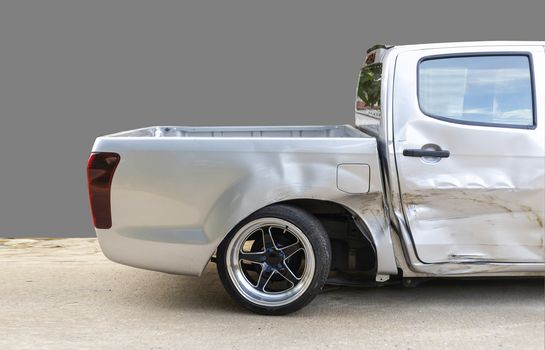 side of light gray color car with pick up damaged and broken by accident on road back wheel  abnormal can not drive any more. Isolate with cliping path