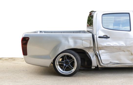 side of light gray color car with pick up damaged and broken by accident on road back wheel  abnormal can not drive any more. Isolate with cliping path