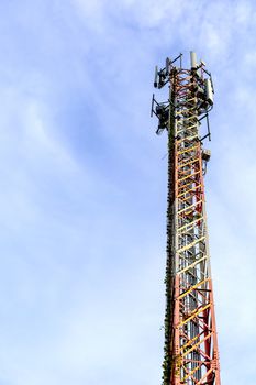 mobile phone communication and network signal repeater antenna tower with blue sky background