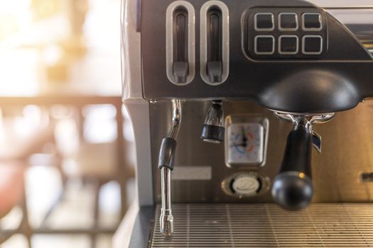 Close-Up of coffee machine in the coffee shop on morning time with sun light effect. len blur effect focus of coffee machine