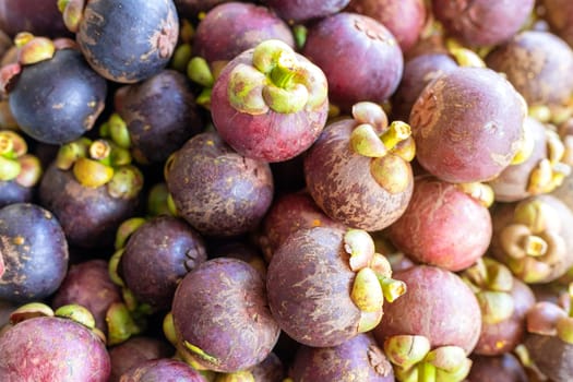 Close up queen of fruits group mangosteen background, Mangosteen in a tray. With Sun light effect