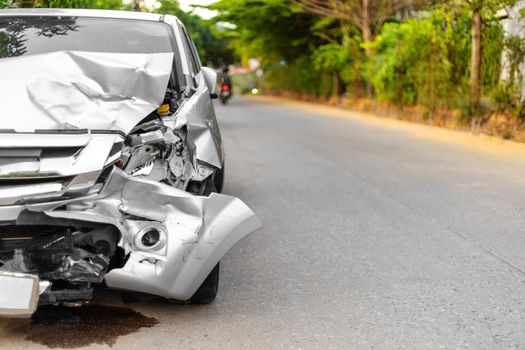 Front of light gray car big damaged and broken by accident on road parking can not drive any more. With copy space for text or desin
