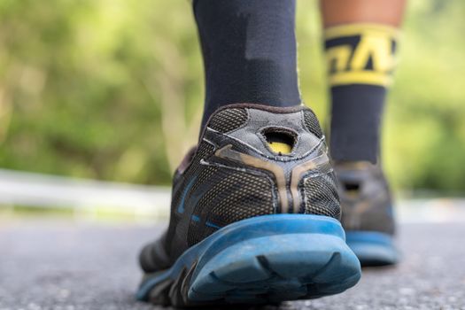 Start to run concept. Man runner feet on road in Park workout wellness soft focus and focus close up on shoe . With copy space for text or design
