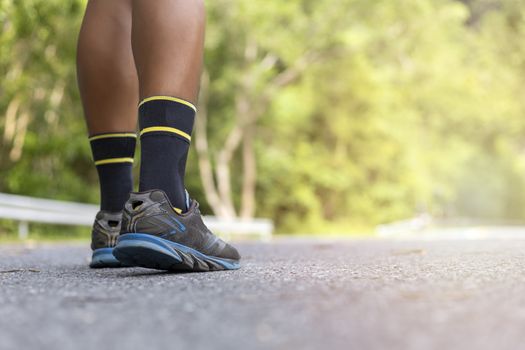 n road in Park workout wellness soft focus and focus close up on shoe  with copy space for text or design