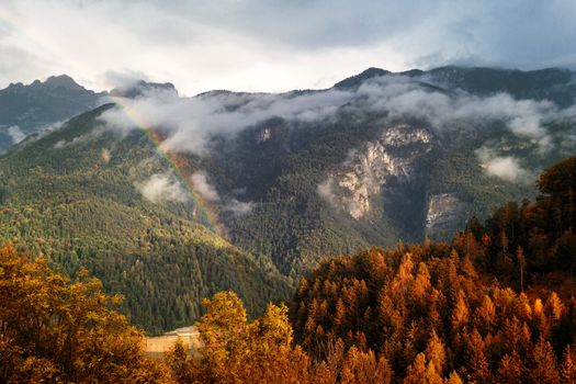 Autumn colors over the hills after the rain, Cadore, Italy, dolomites