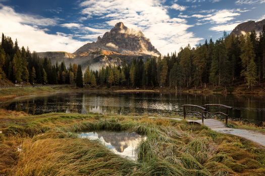 Late autumn wih red colors at Antorno lake with beautiful Tre Cime di Lavaredo mountain reflection. Italy, Europe