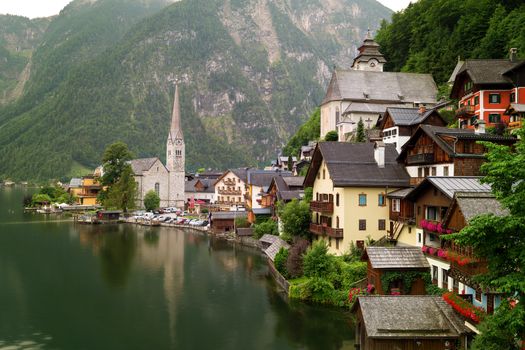 Scenic picture-postcard view of famous historic Hallstatt mountain village with Hallstattersee in the Austrian Alps in mystic twilight during blue hour at dawn in summer, Salzkammergut region, Austria