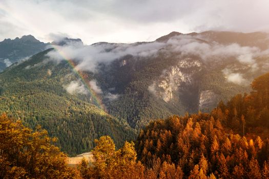 Autumn colors over the hills after the rain, Cadore, Italy, dolomites