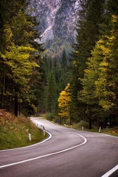 A road thru mountain pass in dolomites during autumn with beautiful colors, Italy, Europe