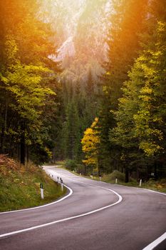 Beautiful autum colors and a mountain road. Path to mountain pass, dolomites, Italy, Europe.