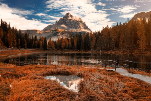 Late autumn wih red colors at Antorno lake with beautiful Tre Cime di Lavaredo mountain reflection. Italy, Europe