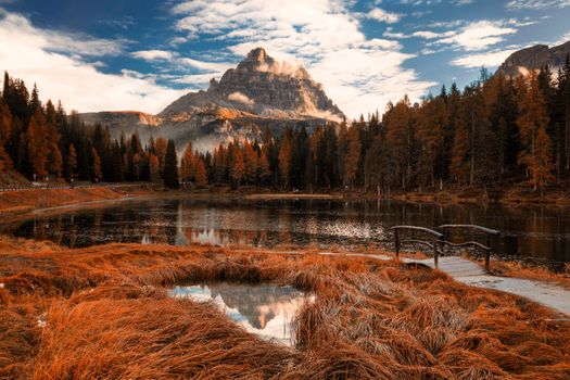 Late autumn wih red colors at Antorno lake with beautiful Tre Cime di Lavaredo mountain reflection. Italy, Europe