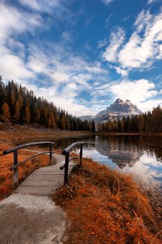 Foot path at Antorno lake, morning view of famous Tre Cime di Lavaredo (Drei Zinnen) during autumn, Italy, Europe.