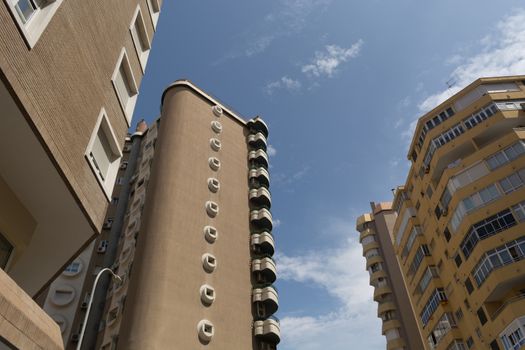 View of the modern multi-storey apartment buildings and sky view. Low angle view of building in downtown Malaga