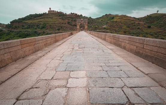 The Alcantara Bridge also known as Trajan Bridge at Alcantara is a Roman bridge at Alcantara, in Extremadura, Spain. Slow shutter speed shot. Vanishing point and copy space available.