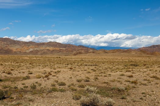 white clouds on the tops of mountains in the region of Issyk-Kul Lake, Kyrgyzstan.