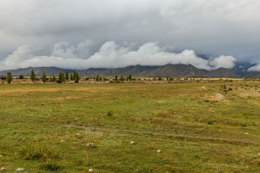 cloudy sky and low clouds in the mountains of Kyrgyzstan, the northern shore of Lake Issyk-Kul