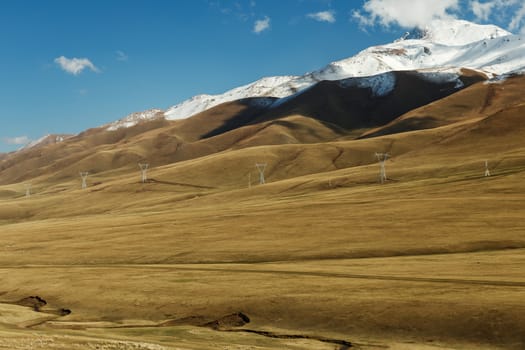 The snowy peaks of the mountains along which the power line passes in Kyrgyzstan.