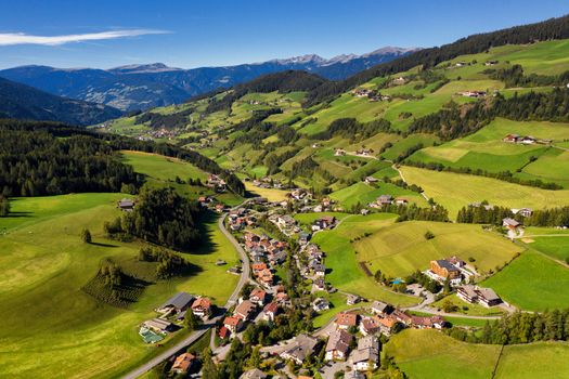 Val di Funes, Trentino Alto Adige, Italy. The great autumnal colors shines under the late sun with Odle on the background and Santa Magdalena Village on the foreground.