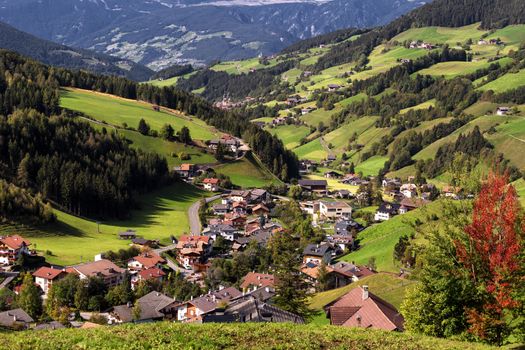 Val di Funes, Trentino Alto Adige, Italy. The great autumnal colors shines under the late sun with Odle on the background and Santa Magdalena Village on the foreground.