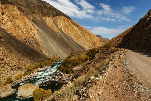 mountain road along the fast river, Kokemeren river, Jumgal District in Naryn Region of Kyrgyzstan