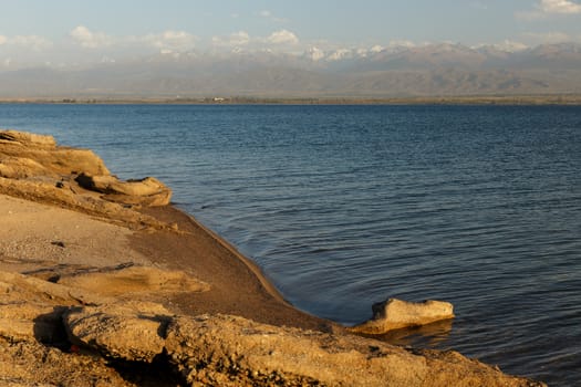 sandy beach on the southern shore of Lake Issyk-Kul in Kyrgyzstan.
