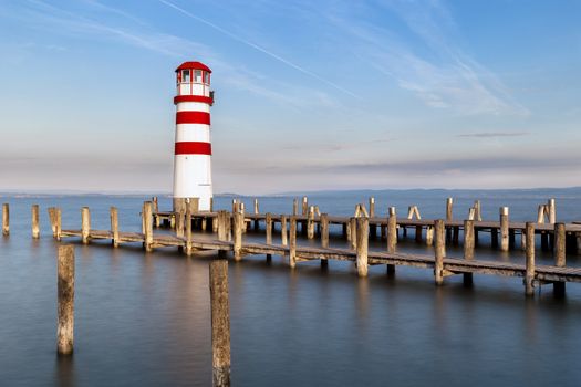 Lighthouse and ponds at the lake during morning golden hour