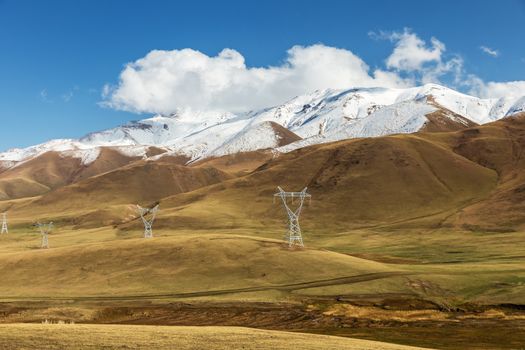 pylons of high voltage power lines in the mountains in the Naryn region of Kyrgyzstan