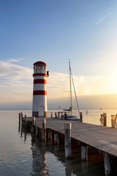 Lighthouse and a boat waiting for sunset