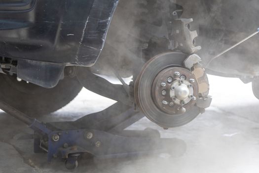 Mechanic use air gun clean disc break take dust removes before change break pat.